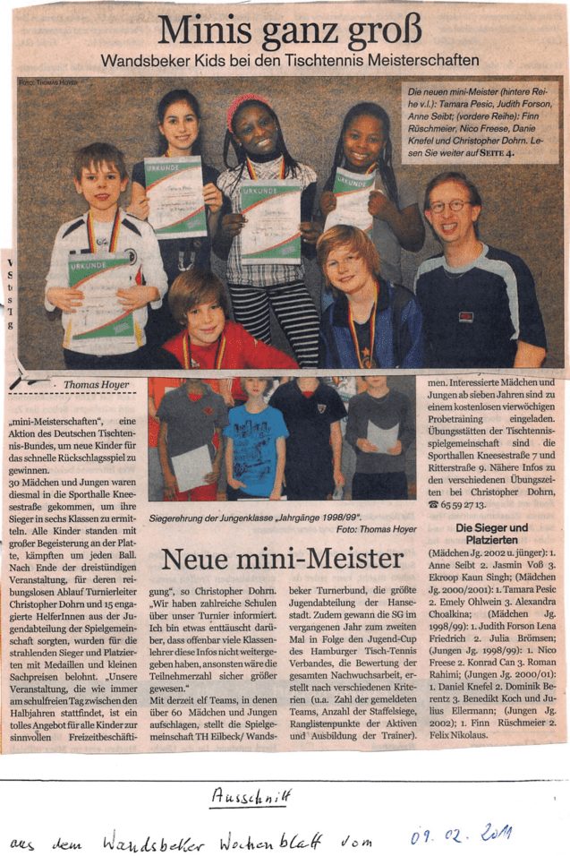 Gruppe von Kindern mit Urkunden und Medaillen bei den Tischtennismeisterschaften, lächelnd vor einer Wand.